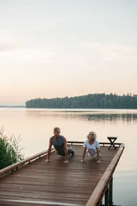 elderly-couple-exercising-on-brown-wooden-dock-8795592