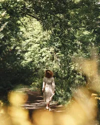 woman-wearing-long-sleeves-printed-dress-walking-on-dirt-ground-betwee-8688958
