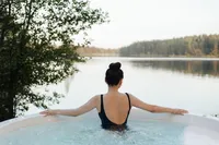 Woman relaxing in an outdoor jacuzzi as part of a natural health and wellness lifestyle