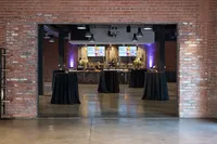 Corporate event venue prepared with cocktail tables, floral arrangements, catering stations and event lighting in Phoenix Arizona
