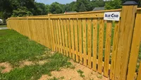 Newly installed wood privacy fence running straight and level along a residential property line in the Baltimore area by Blue Crab Fence & Home.