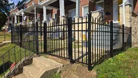 Black aluminum spear-top fence installed along a landscaped residential front yard in the Baltimore area by Blue Crab Fence & Home.