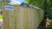 A straight, continuous wood privacy fence securing a residential property line in Maryland.