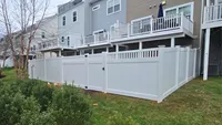 White vinyl privacy fence with decorative spindle-top accents installed in a Maryland residential backyard by Blue Crab Fence & Home.