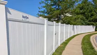 Custom white vinyl privacy fence curving smoothly along a residential concrete sidewalk in the Baltimore Metro area, installed by Blue Crab Fence & Home.