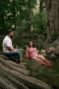 Expecting parents relaxing in the creek and talking.