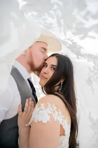 A Quiet Kiss Beneath the Bridal Veil.