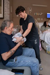 Old man meets his great granddaughter for the first time after birth.