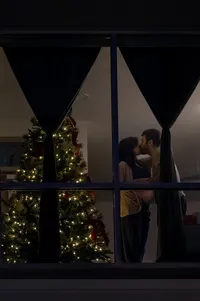 A Christmas Maternity Embrace Seen Through the Window.