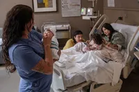 Family Gathers Around the Hospital Bed.