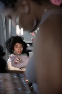 Bride looks at herself in the mirror as she gets ready for her wedding day.