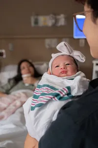 Newborn Wrapped in a Blanket with a Bow.