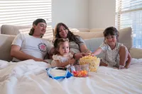 Sharing Popcorn During Family Movie Night.