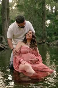 Expecting Parents Share a Smile in the Creek.