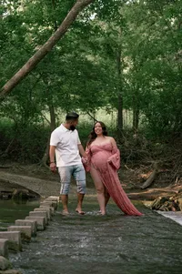 Expecting Parents Stand Together Beside the Creek.