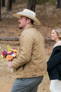 Groom holds his brides hand as they walk to their elopement location.