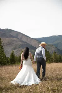 Newlyweds Walk Toward the Mountains.