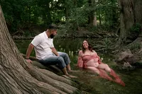 Expecting Parents Relax Together in the Creek.