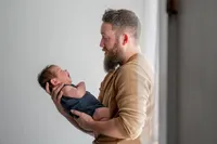 A Father Cradles His Newborn.