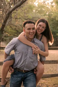 Man giving his fiancé a piggy back.