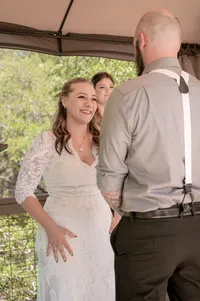 Bride smiles at her groom during their backyard wedding.