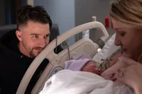 A Father Watches the First Cuddle.