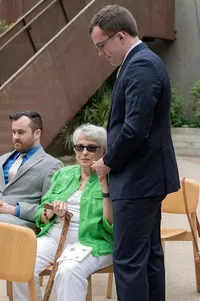 Grandmother hold her grandsons hand before the wedding.