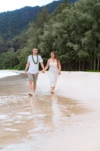 Newlyweds Walk Along the Shore.