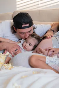 A Family Cuddle Beside the Baby Bump.