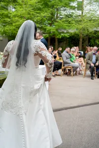 Bride standing before all her guests as she prepares to walk down the isle.