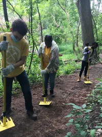 Copy of Karim, Macy, and Quintasia tamp the newly leveled trail