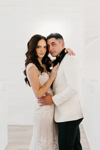 Bride wearing soft glam makeup with glowing skin and glam waves with hair extensions