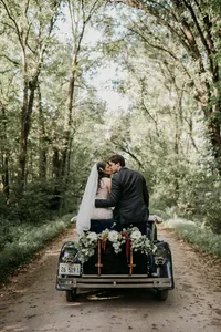 Bride wearing soft glam bridal makeup with glowing skin and lashes with glam waves with hair extensions