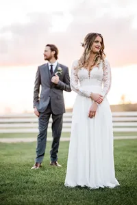 A bride with soft glam makeup and a romantic boho half up hairstyle