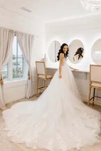 Bride wearing soft glam makeup with glowing skin and glam waves with hair extensions