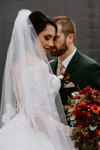 A bride with full glam makeup and a romantic updo with loose face framing pieces