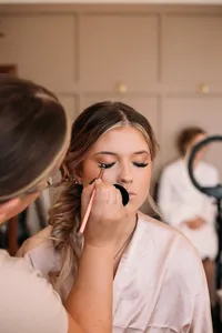 A bride getting soft glam makeup done by The Bridal Glam Group
