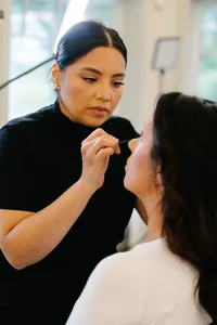 A bride getting full glam makeup done by The Bridal Glam Group and glam waves