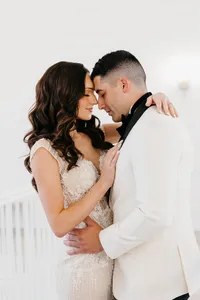 Bride wearing soft glam makeup with glowing skin and glam waves with hair extensions