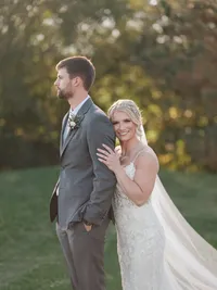 Bride wearing soft glam bridal makeup with glowing skin and lashes with a romantic updo hairstyle