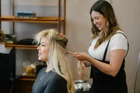 Bride getting ready with The Bridal Glam Group getting a romantic bridal braid with loose face framing pieces