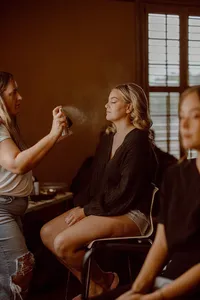 A bride getting soft glam makeup done by The Bridal Glam Group and glam waves
