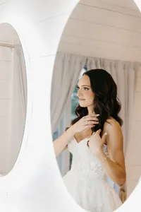 Bride wearing soft glam makeup with glowing skin and glam waves with hair extensions