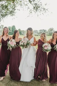 Bride and bridesmaids wearing soft glam makeup and romantic hairstyles