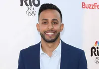 Anwar smiling in a blue suit at a Rio 2016 media event