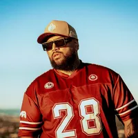 Hori Humor wearing a red number 28 jersey, cap and sunglasses outdoors