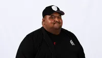 Uce Gang wearing a black cap against a white studio background