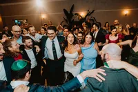 Wedding guests dancing together during an evening reception