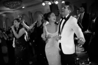 Black and white photograph of wedding couple on stage with Legacy