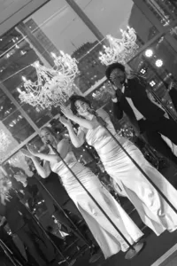 Black and white photograph capturing a live musical performance of Legacy's lead vocalists.